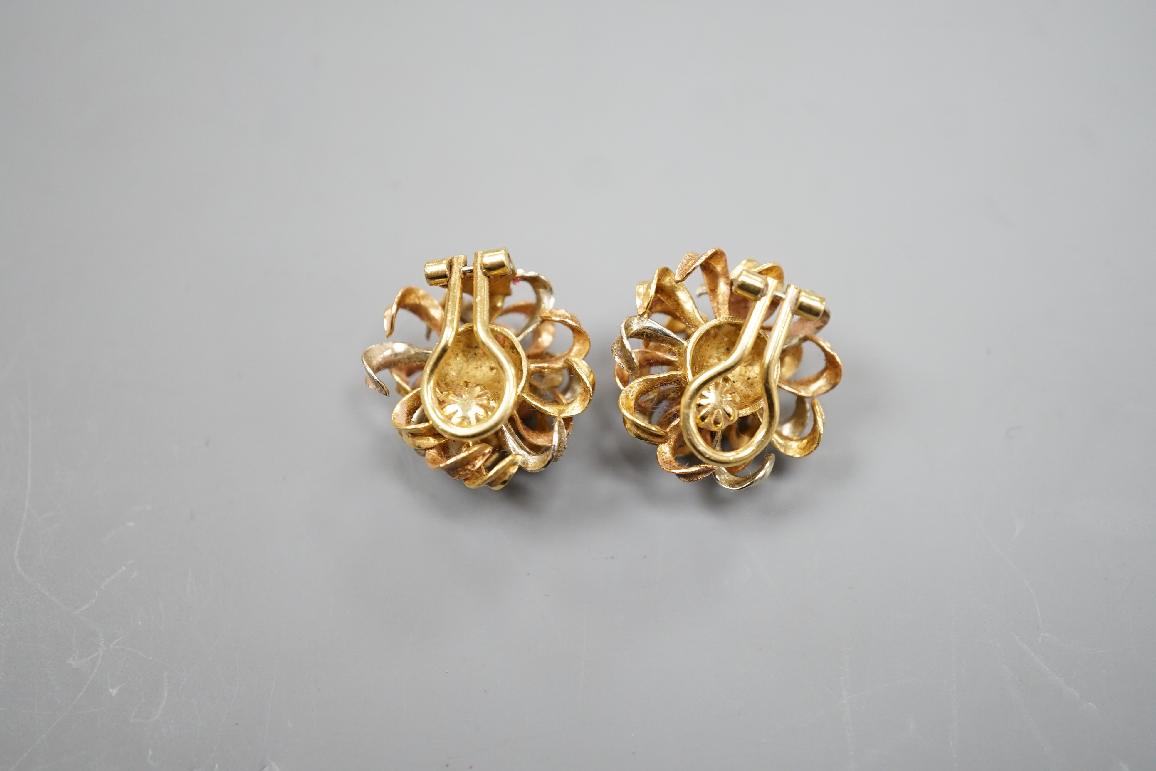 A modern pair of three colour 750 yellow metal scrolling ear clips, 23mm